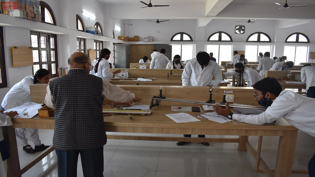 Students performing physics experiment